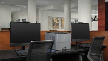 A modern office space with cubicles, computers, and office chairs.
