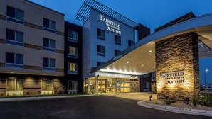 A Fairfield Inn & Suites Marriott hotel entrance with a stone facade and multiple windows. - Fairfield Inn & Suites by Marriott Butte (Butte)