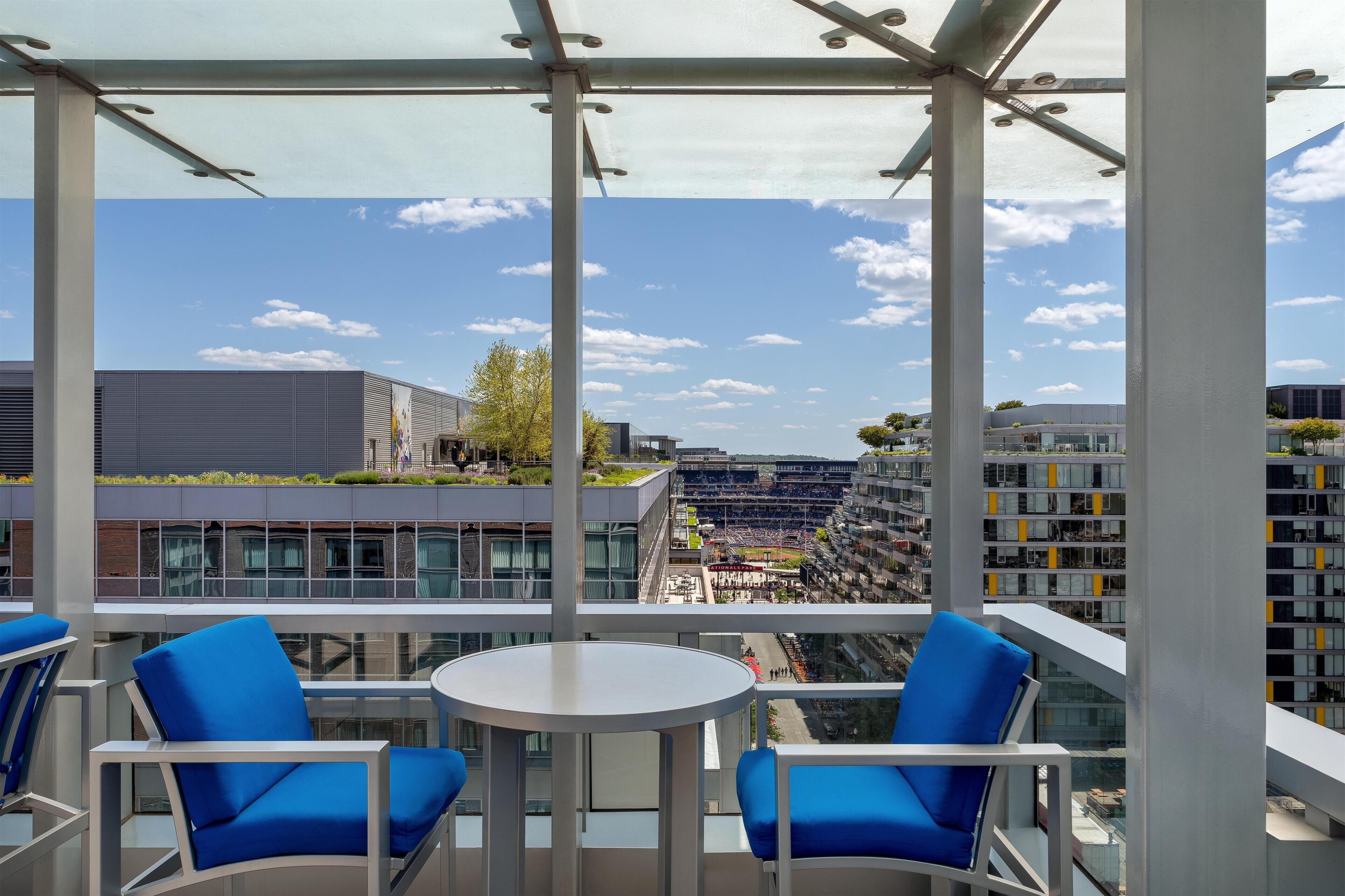 A modern outdoor seating area with a clear view of the cityscape.