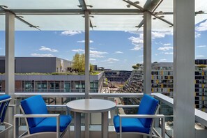 A modern outdoor seating area with a clear view of the cityscape.