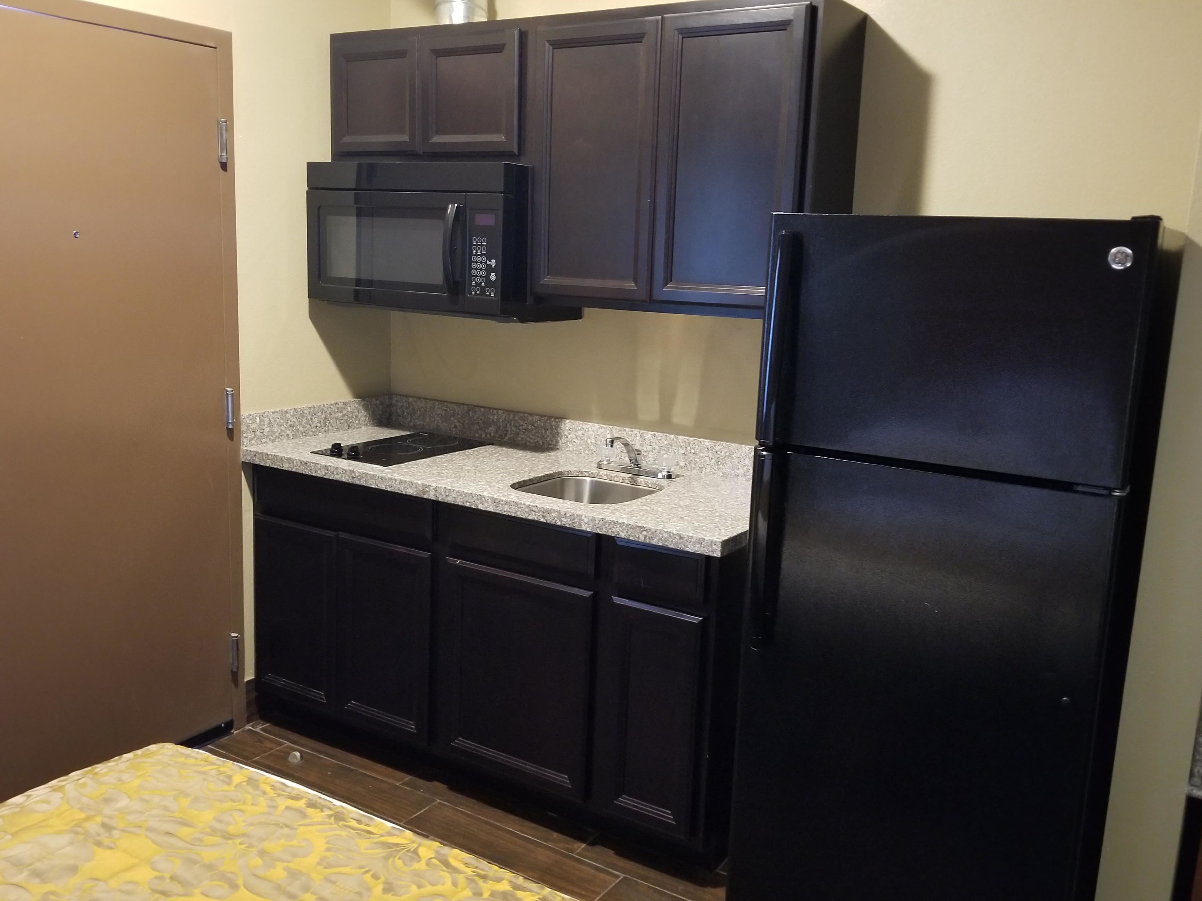 full-sized fridge, microwave, stovetop, coffee/tea maker