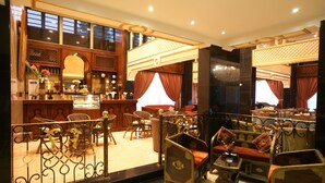 A traditional interior with wooden furniture, a bar area, and decorative elements. - Roshan Al Azhar Hotel (Jeddah)