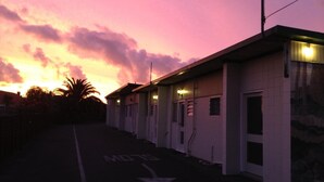A row of single-story buildings with a parking area marked with a 'STOP' sign. - Parkview Motel (Dargaville)