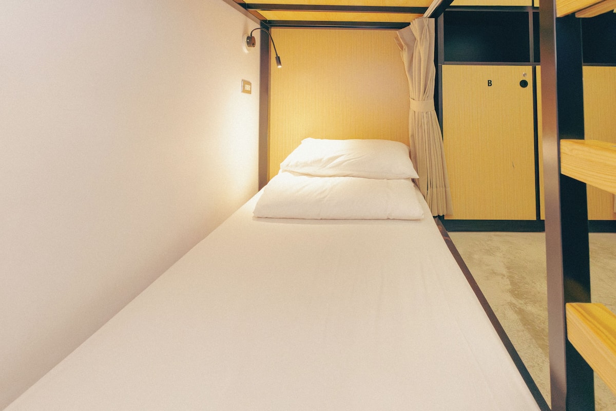 A bunk bed with a single bed at the bottom and a bunk above.