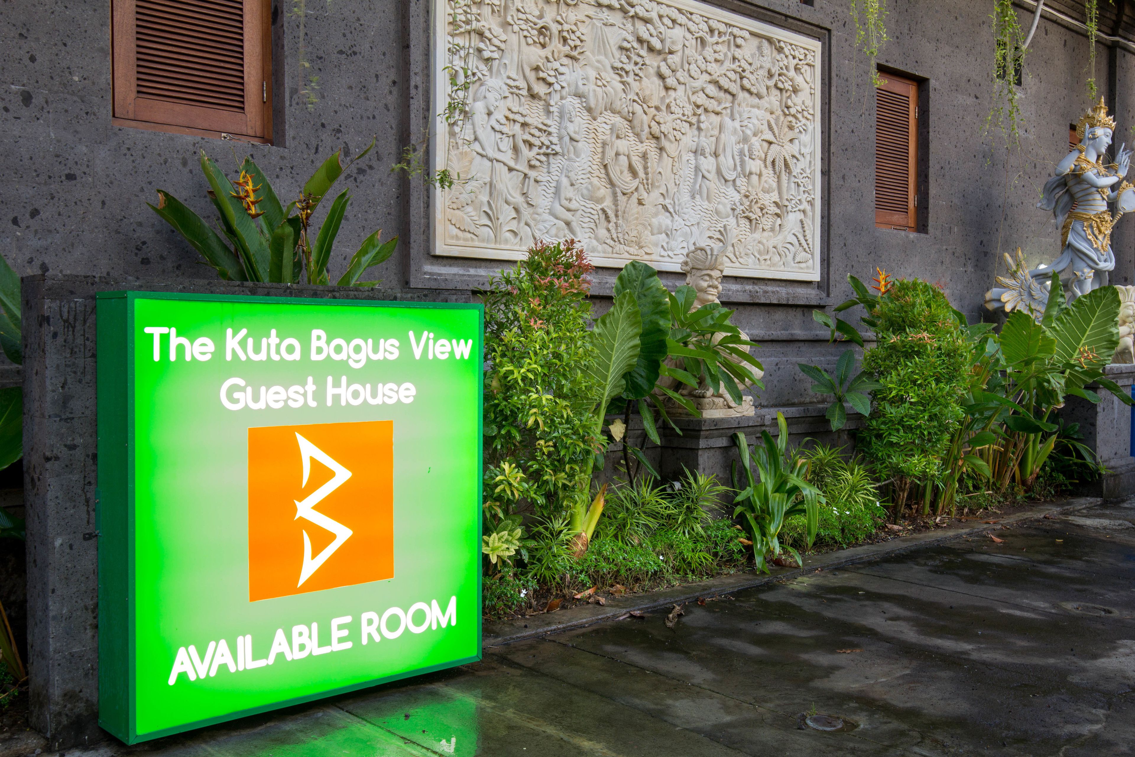 A sign for The Kuto Bagus View Guest House indicating an available room.