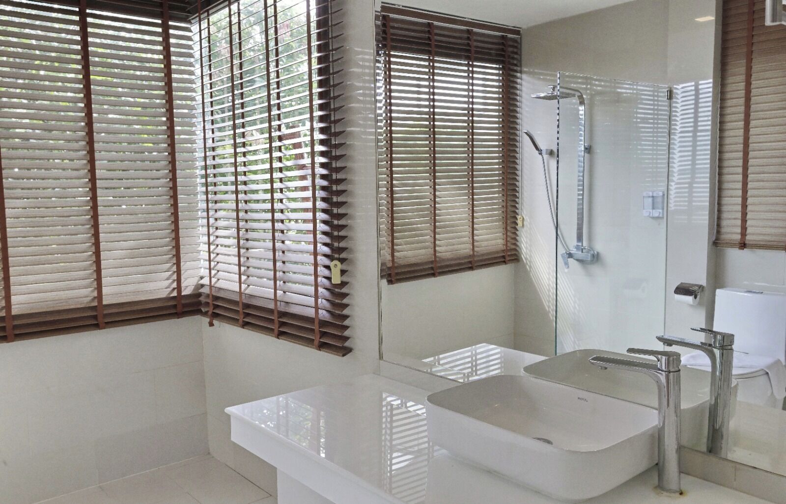 A modern bathroom with a large bathtub, a separate shower area, and a vanity with a mirror.
