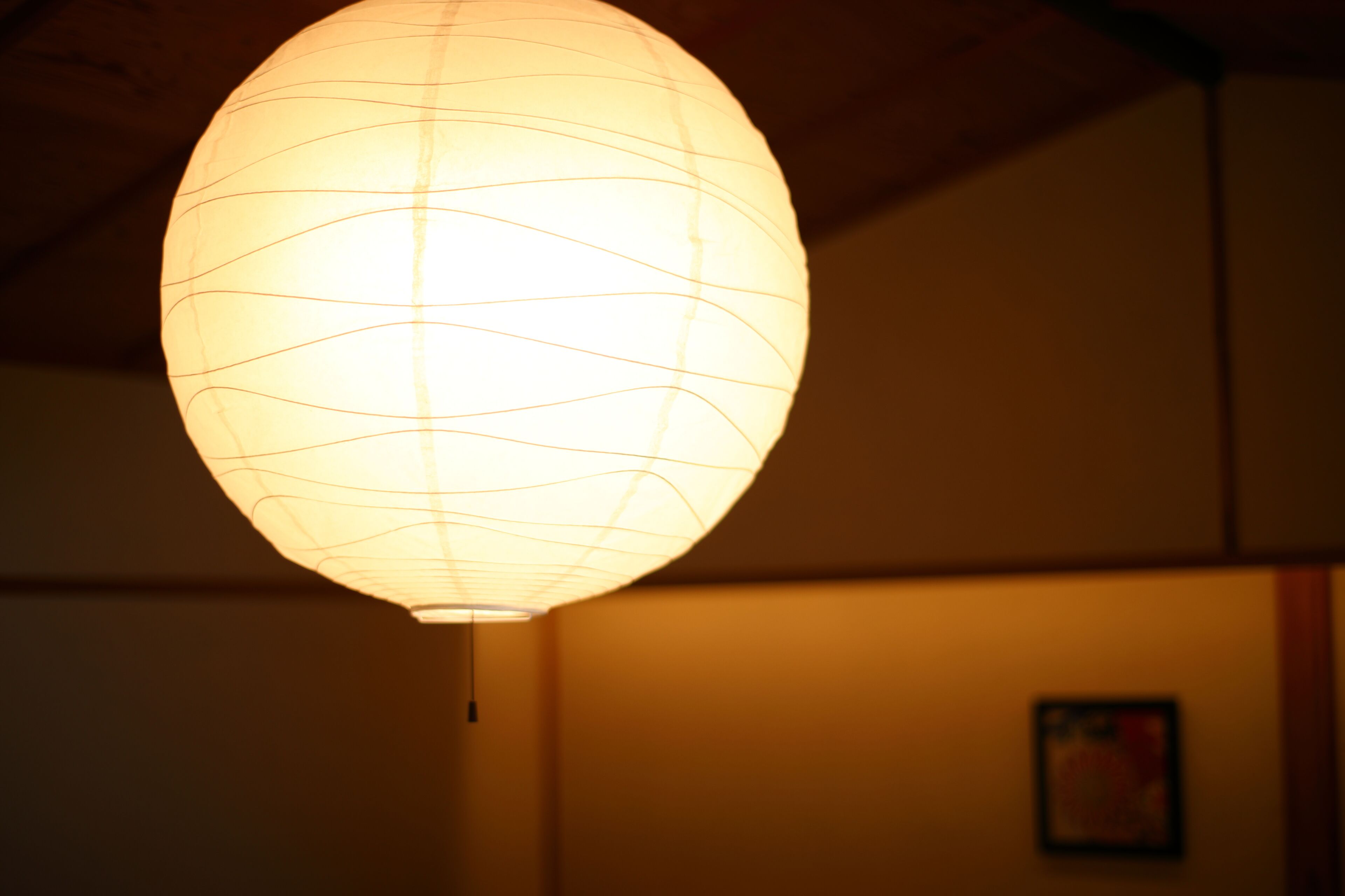 A hanging paper lantern with a grid pattern.