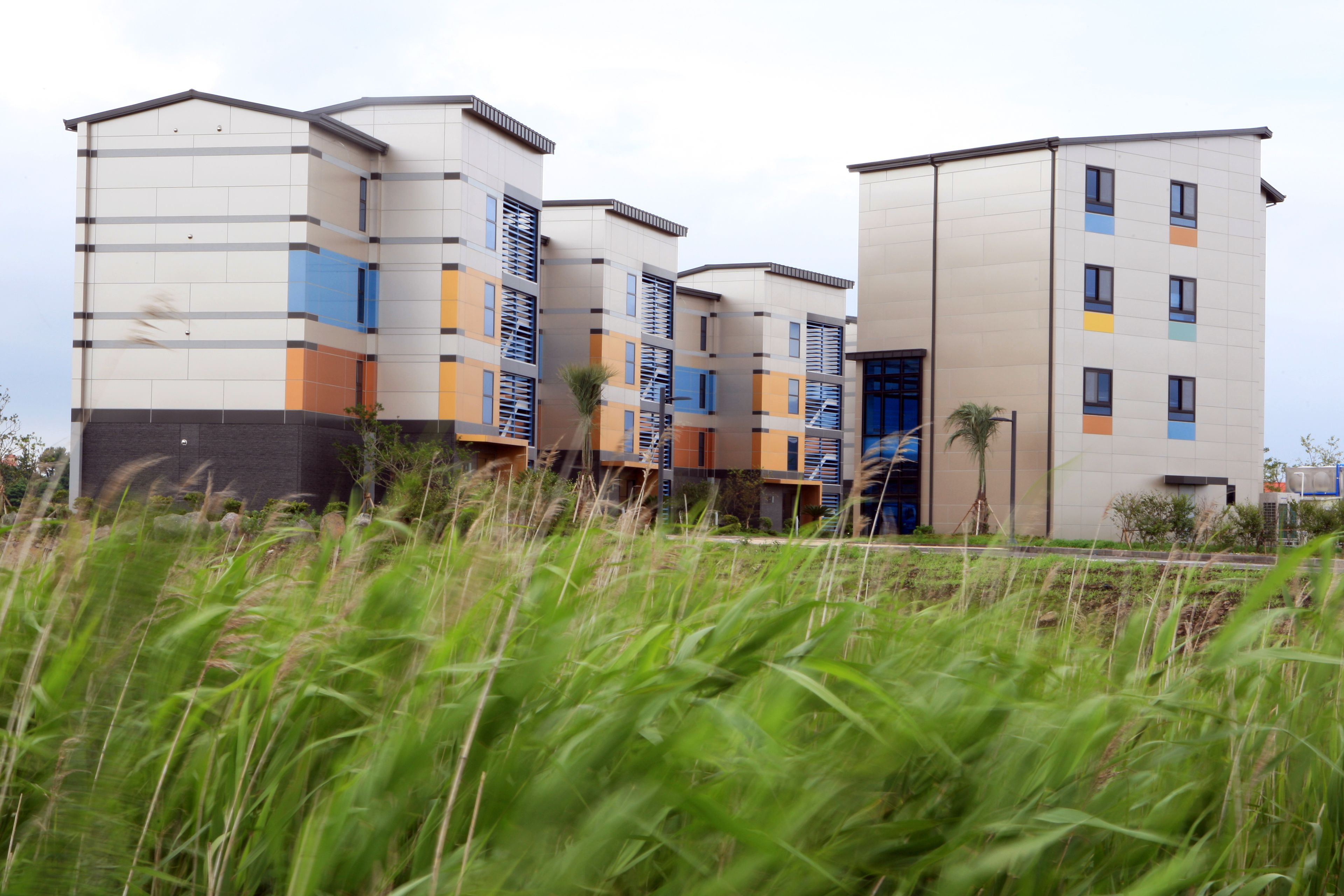 A modern multi-story building with a mix of residential and commercial spaces.