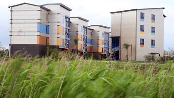 A modern multi-story building with a mix of residential and commercial spaces.
