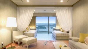 A hotel room with a large window, two beds, a sofa, a coffee table, and a floor lamp. - Shirahama Coganoi Resort&Spa (Shirahama)