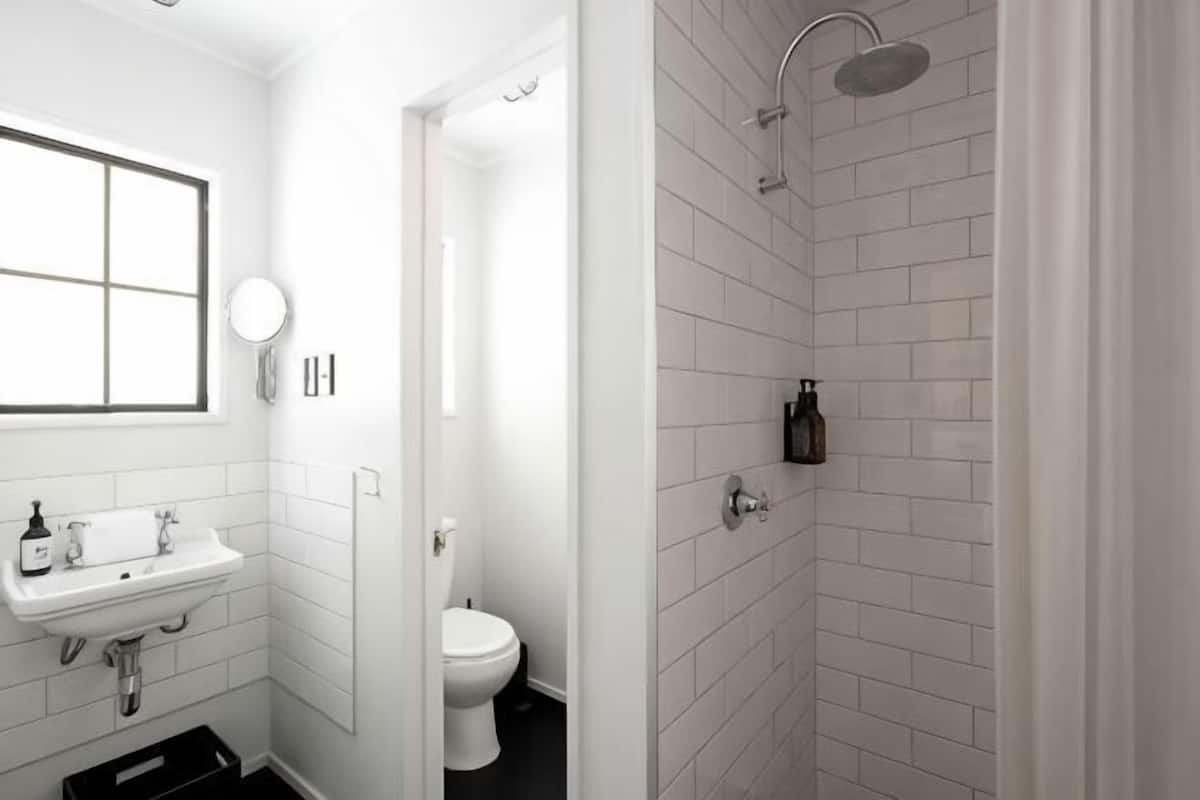 A bathroom with a sink, toilet, and shower.
