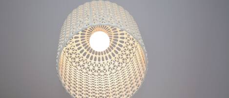 A spherical, intricately designed light fixture with a central circular opening.