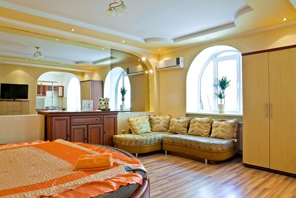 Romantic Studio Suite, Balcony (Zheltoksan Street 78) | Living area | 32-inch flat-screen TV with cable channels, LCD TV - Lessor Apartments (Almaty)