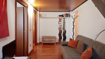 Deluxe Apartment (up to 4 people) | Living area | 20-inch flat-screen TV with digital channels