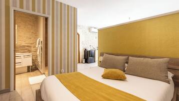 A bedroom with a bed, a wooden headboard, a yellow throw blanket, and a striped wall.