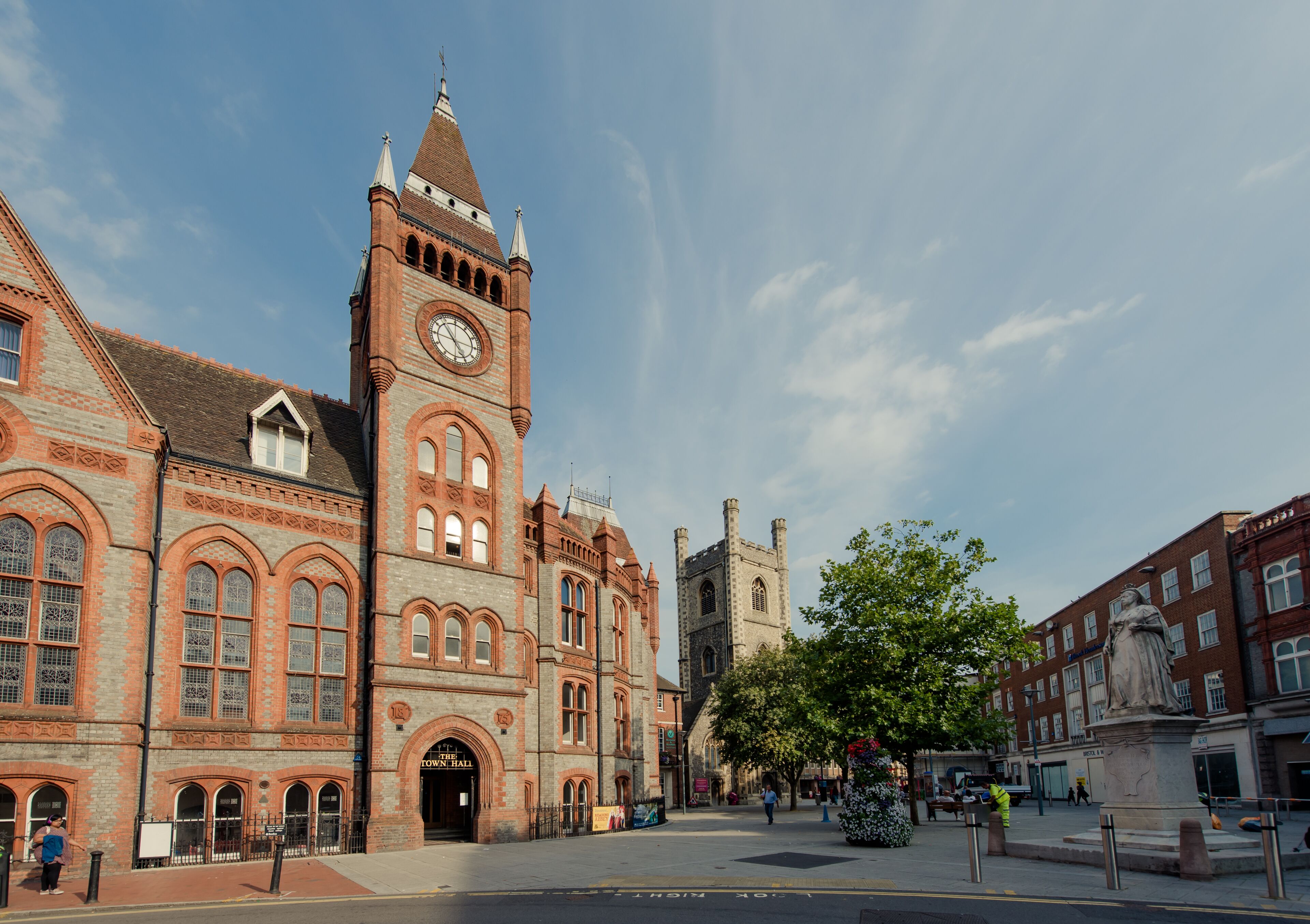 A historic building with a prominent clock tower, arched windows, and a central entrance.