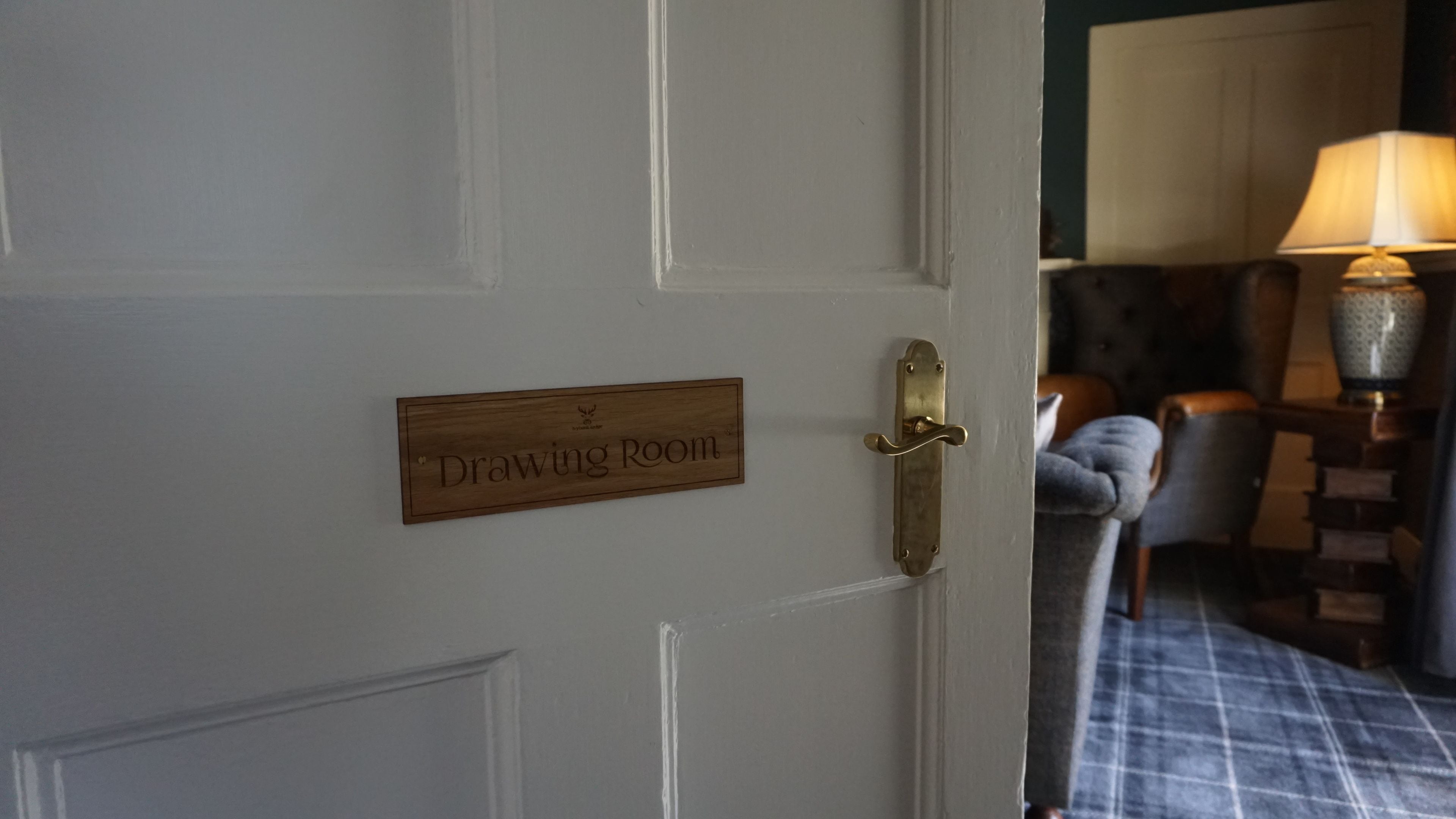 A door with a sign reading "Drawing Room".