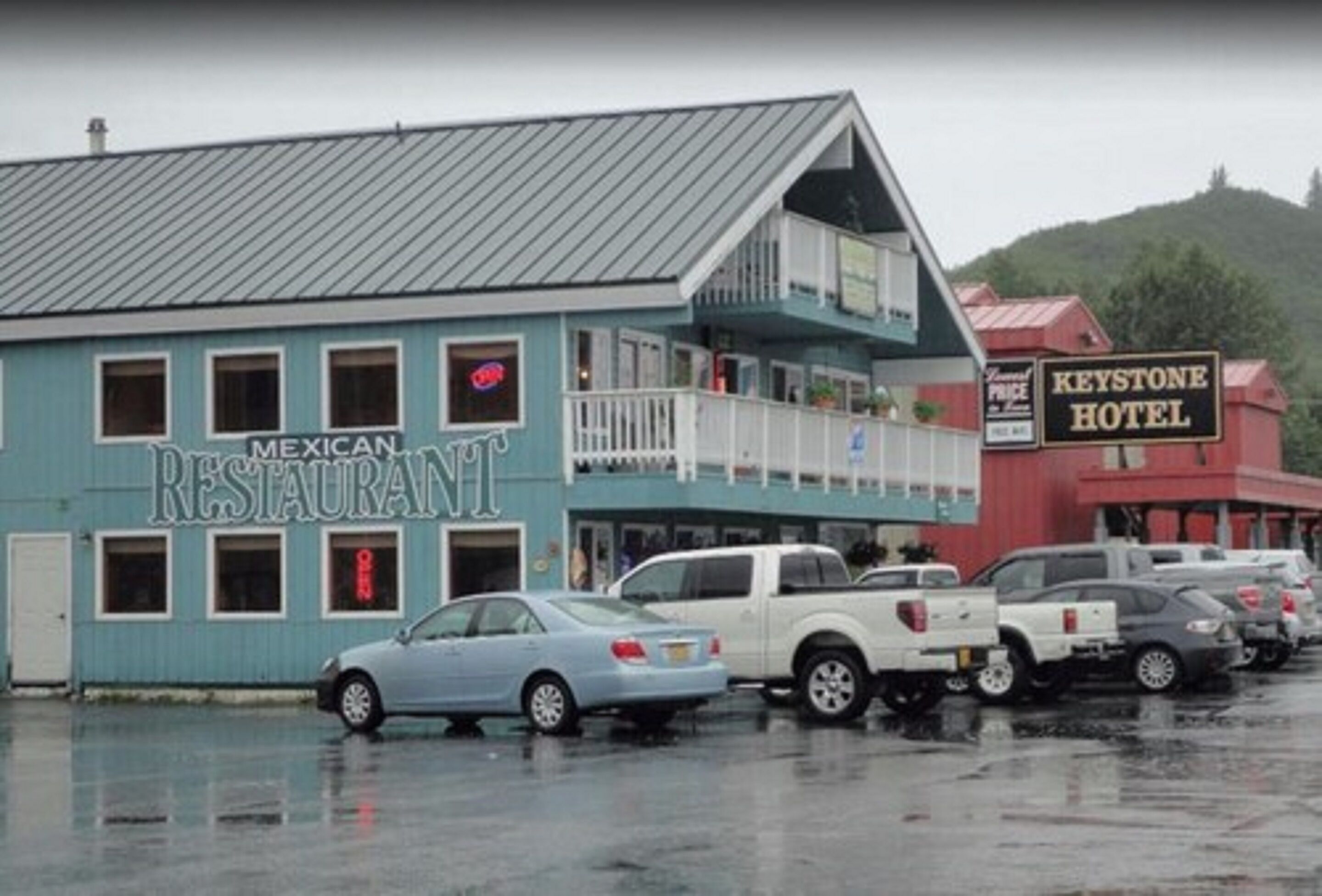 A blue building labeled "Mexican Restaurant" with a balcony and a sign for "Keystone Hotel" in the background.