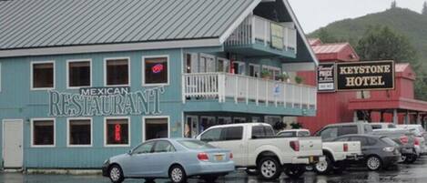 A blue building labeled "Mexican Restaurant" with a balcony and a sign for "Keystone Hotel" in the background.