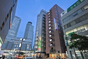A cityscape with modern buildings, including a prominent 33BANK building with a green sign. - Sanco Inn Nagoya Shinkansenguchi (Nagoya)
