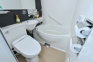 Un baño moderno con inodoro, bidé y lavamanos.