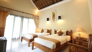 A hotel room with two beds, wooden headboards, and a ceiling with a thatched roof design. - Mutiara Bali (Karangasem)