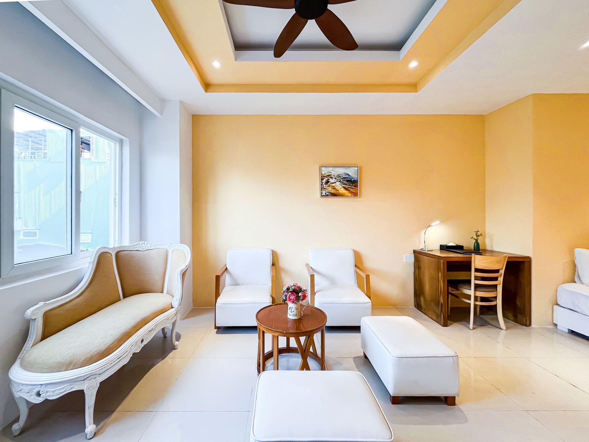 A modern living room with a sofa, two armchairs, a coffee table, and a dining table with chairs.