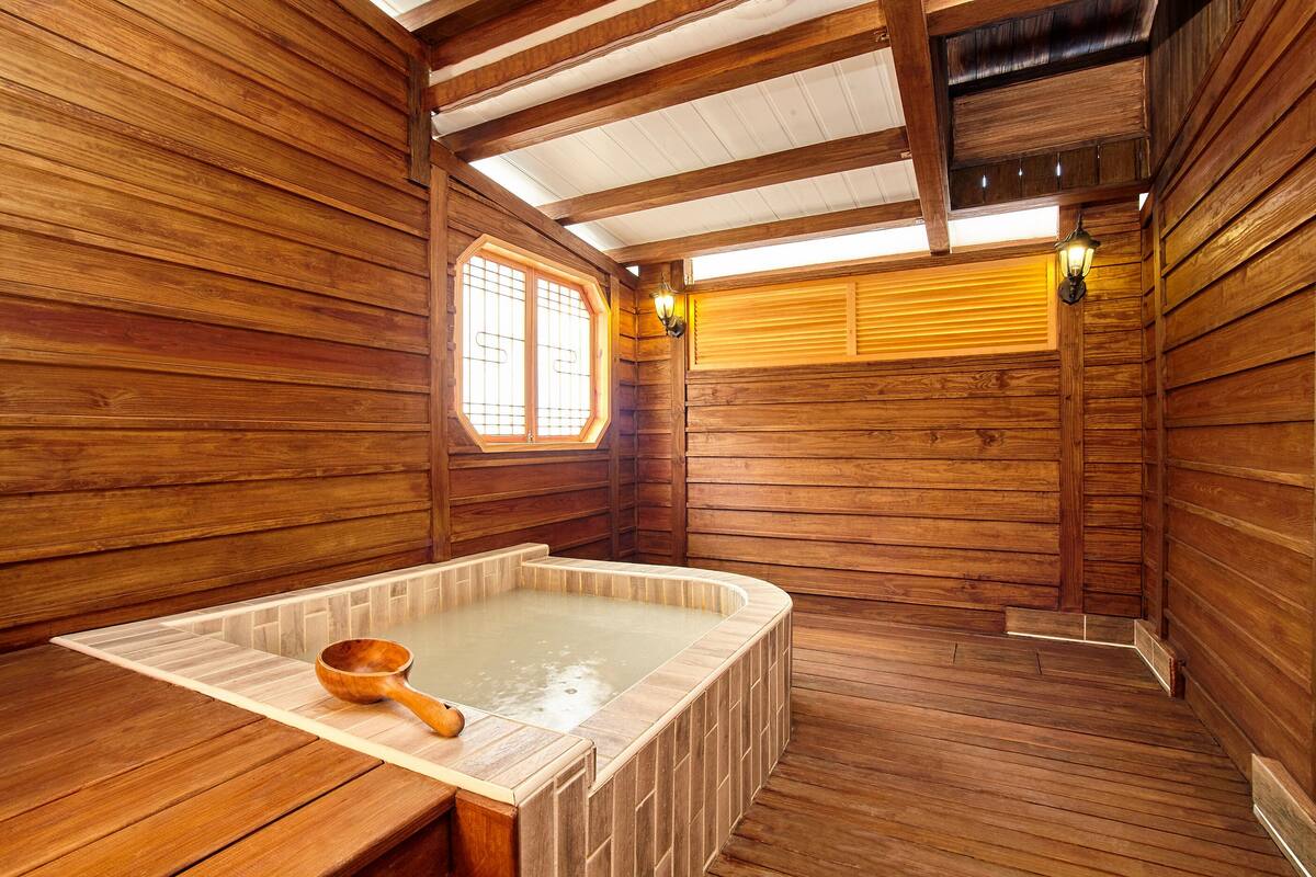 A wooden sauna with a wooden bench and a wooden ladle.