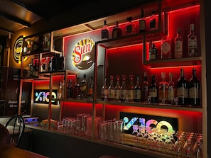 A bar area with shelves of liquor bottles and glasses. - Gold Butik Hotel (Marmaris)