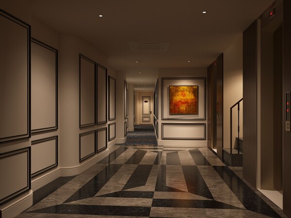 A hotel corridor with a checkered floor, framed artwork, and an elevator. - O'Gallery Signature Hotel & Spa (Hanoi)