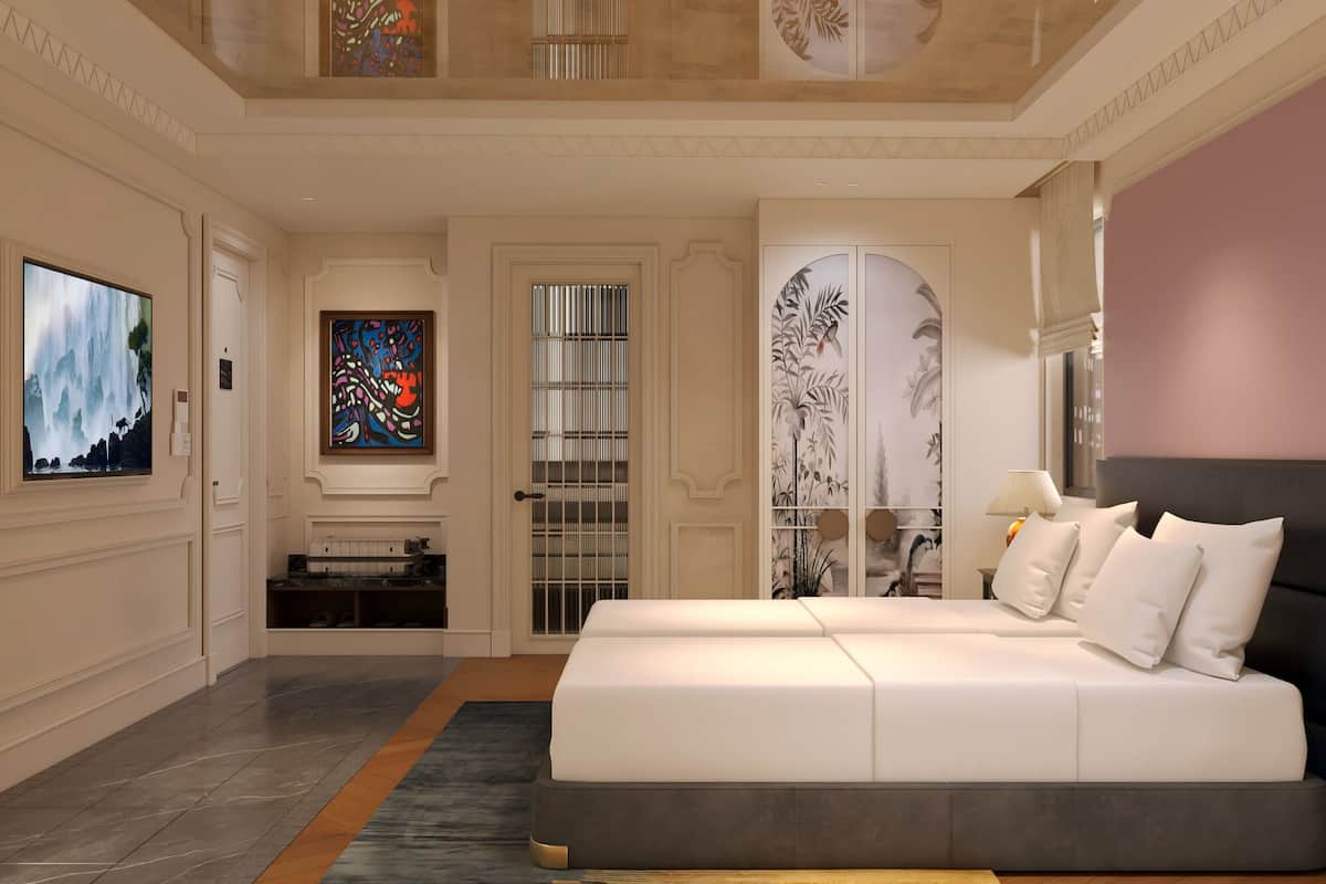 A modern bedroom with a large bed, a television, a decorative wall, and a door with a view.