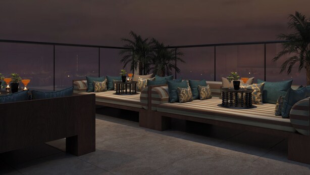 A rooftop lounge with a sofa, chairs, and a small table, surrounded by potted plants and palm trees. - O'Gallery Signature Hotel & Spa (Hanoi)