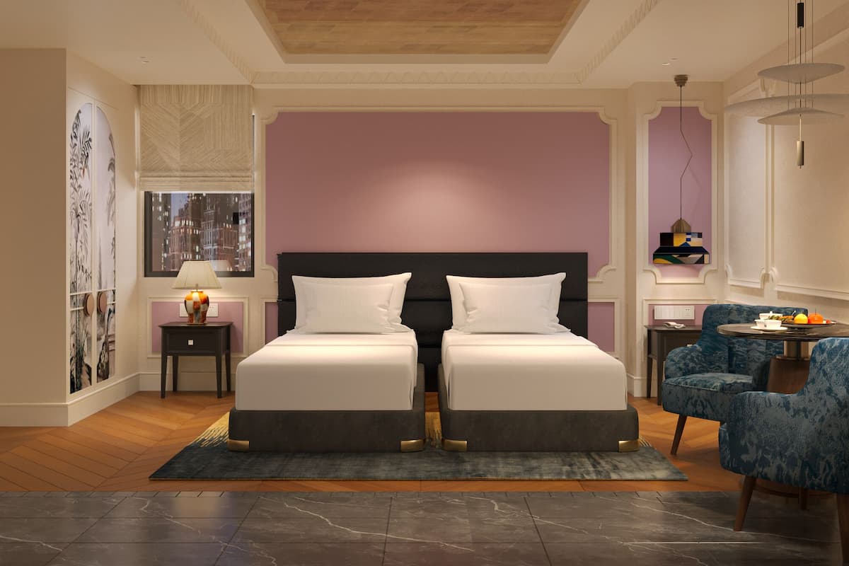 A modern bedroom with a double bed, a side table, a chair, and a cityscape view.