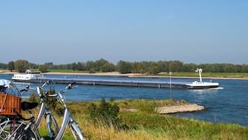 A river with boats, a lock system, and a bicycle with baskets.