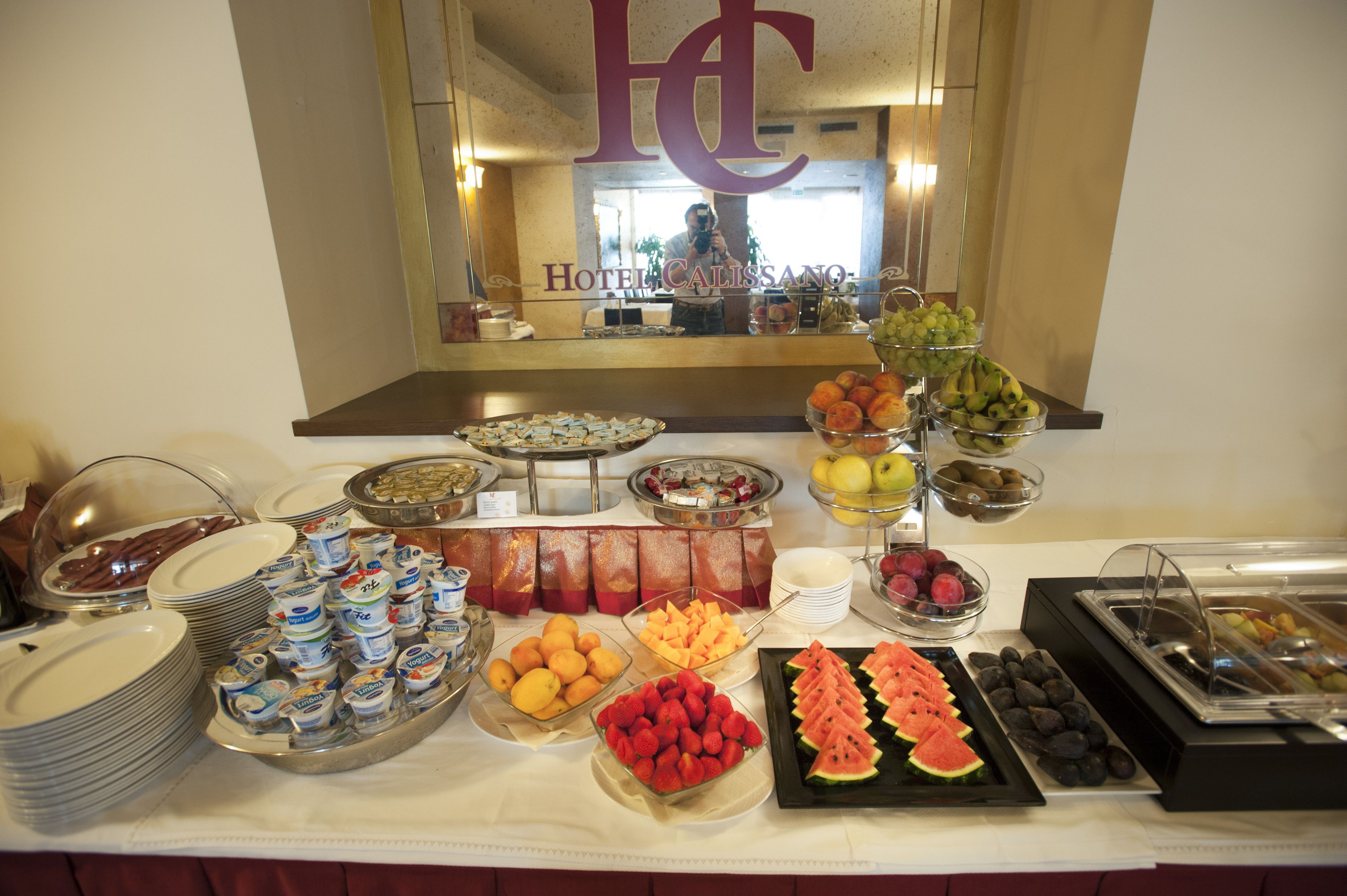A buffet with various fruits, cheeses, and other food items.