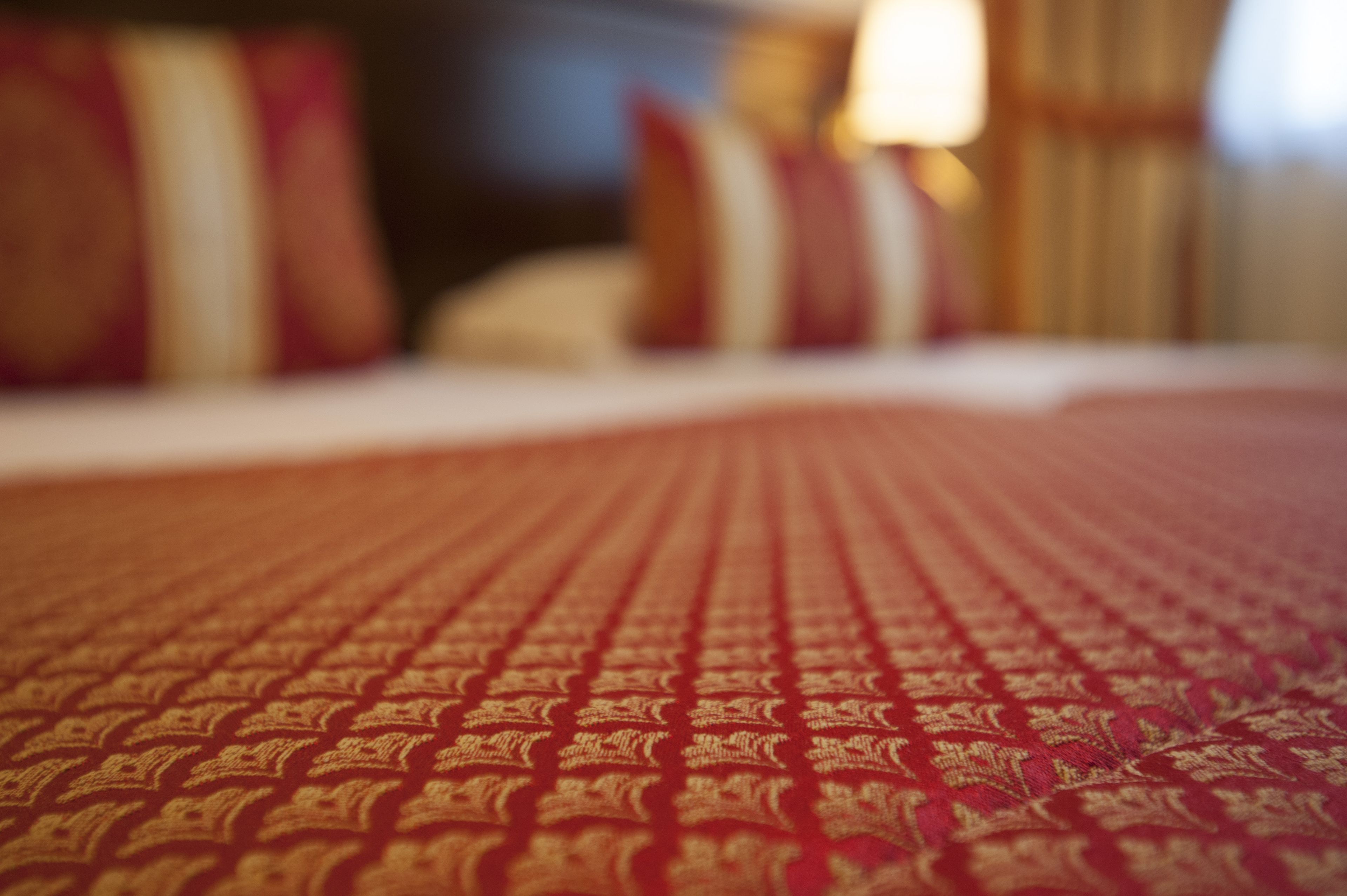 A close-up of a patterned bedspread with a textured design.