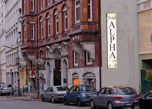 A hotel named "Hotel Alpha" with a classic architectural style, featuring ornate facades and a prominent entrance. - Alpha Hotel-Pension (Hamburg)