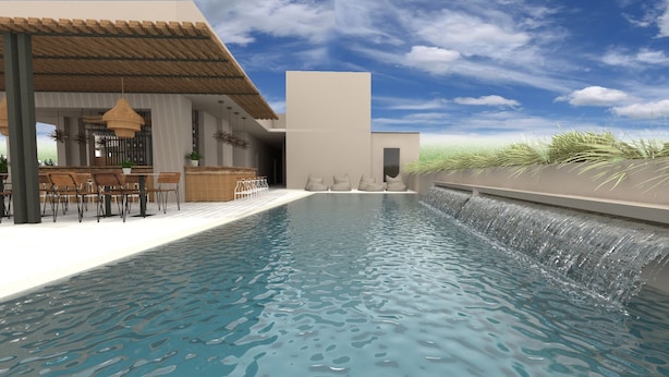 Un espace piscine moderne agrémenté d’une cascade, d’un coin salon extérieur et d’un espace d’accueil.