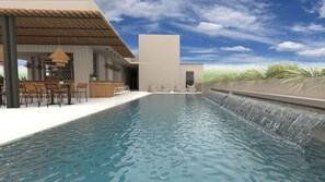A modern pool area with a waterfall feature, outdoor seating, and a reception area. - Zante Flower (Zakynthos)