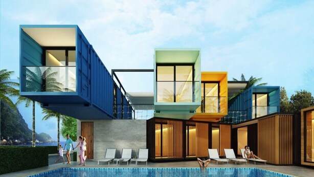 Un hotel moderno con piscina, varios niveles y vista al mar.