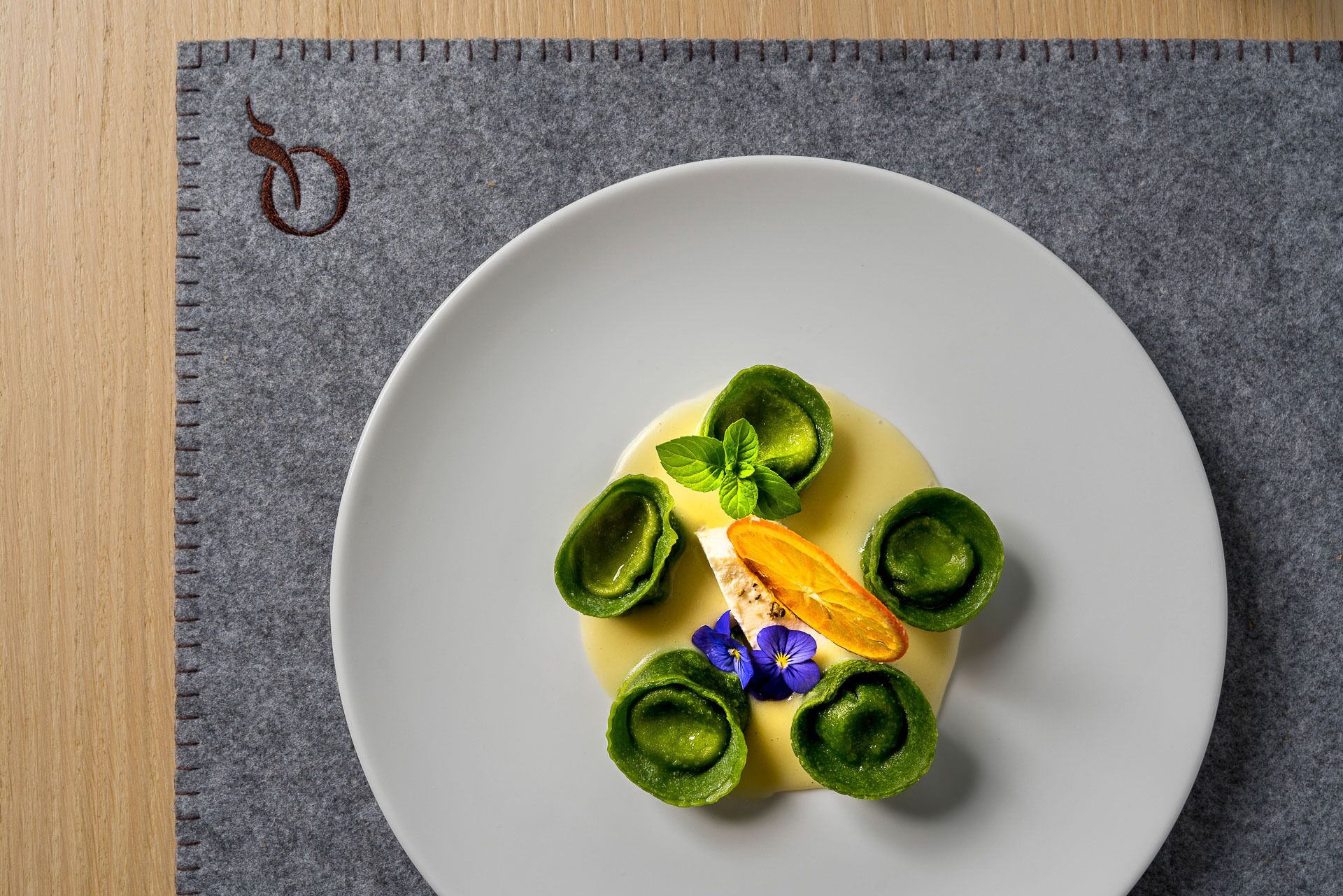 A plate with a dessert on a dark tablecloth.