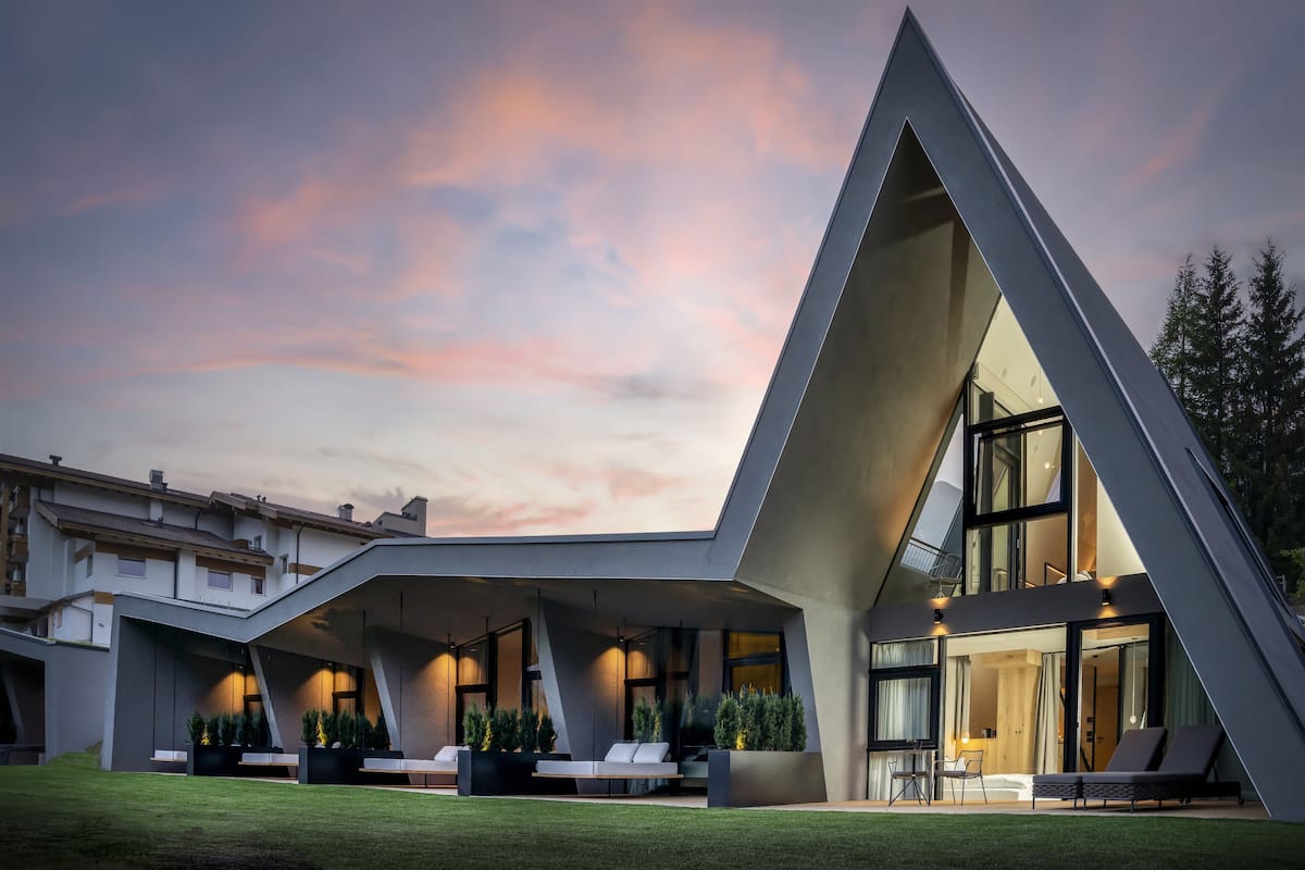 Un edificio moderno con un diseño triangular único, ventanas amplias y zonas de estar al aire libre.