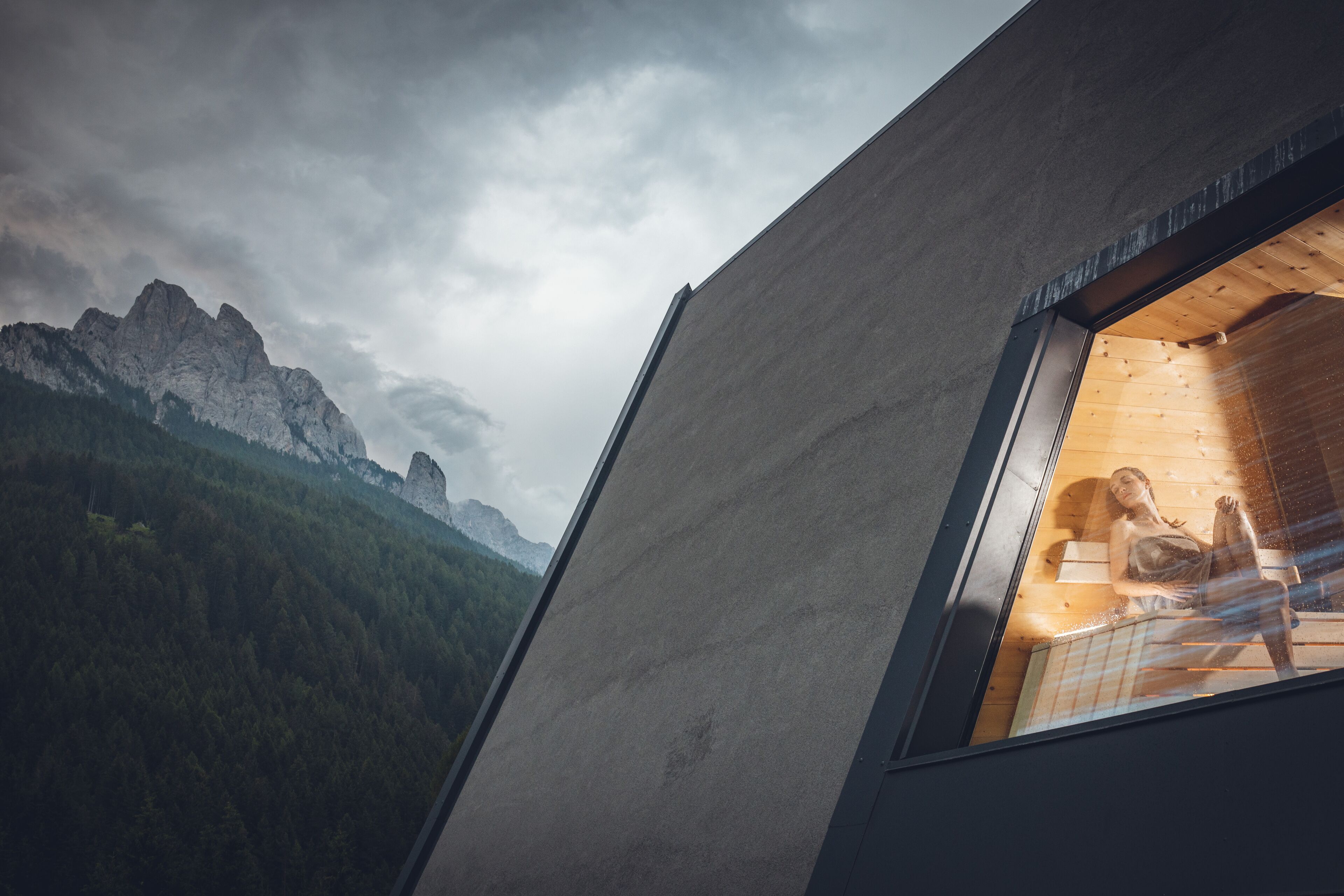 A modern interior with a large window overlooking a mountainous landscape.