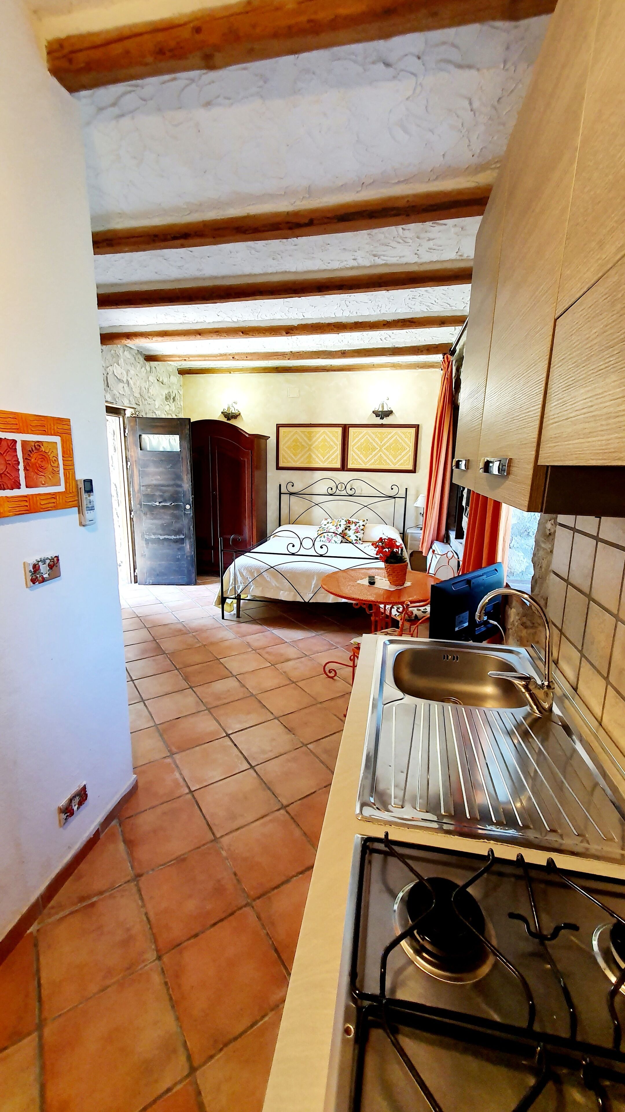 A compact kitchen with a gas stove, a sink, and a dining table.