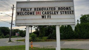 A sign for North Shore Wayside Inn, a motel with a dining lounge, and fully renovated rooms on Causey Street. - North Shore Wayside Inn (Blind River)