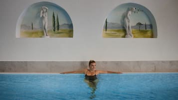 Una piscina cubierta, tumbonas