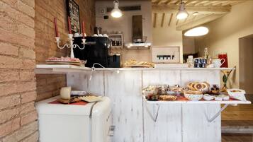 Uma cozinha com bancada de mármore, geladeira e diversos alimentos.