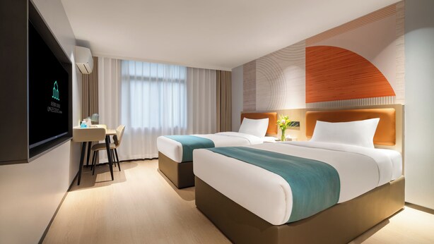 A hotel room with two beds, a desk, a TV, and a large window with curtains. - Guang Dong Hotel (Guangzhou)