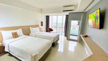A hotel room with two beds, a flat-screen TV mounted on the wall, a balcony with a view, and a modern design.