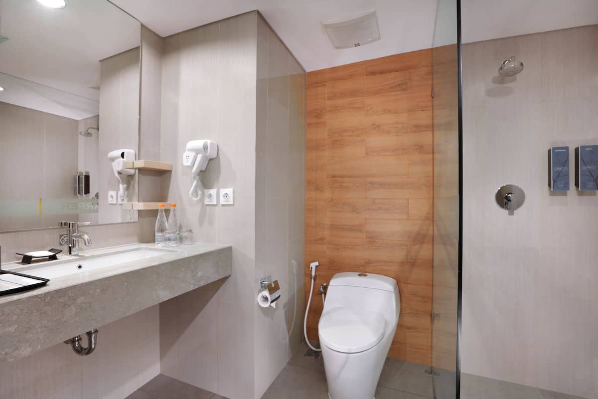 deluxe double or twin room | bathroom | rainfall showerhead, free toiletries, hair dryer, slippers